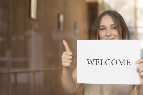 girl-holding-welcome-sign-after-end-quarantine